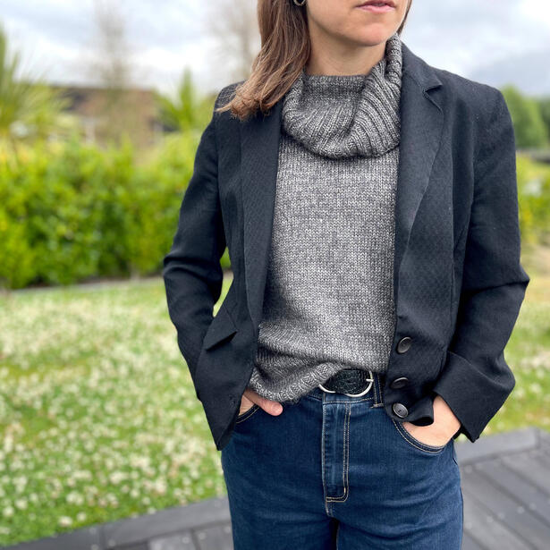 Women wearing a hand knitted vest of mohair and hand dyed yarn and black blazer