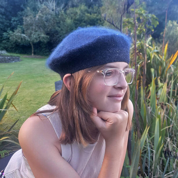 Young women wearing a hand knitted navy beret