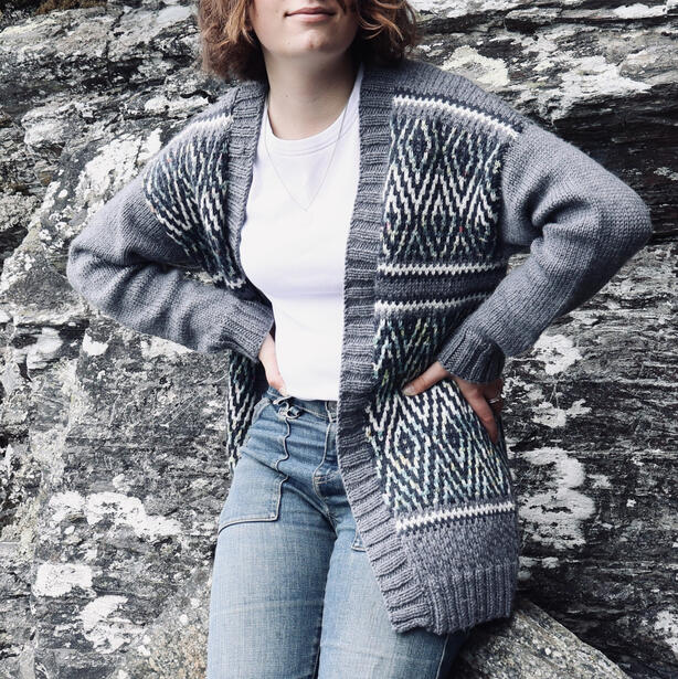 Young woman wearing mosaic stitch multi coloured long cardigan
