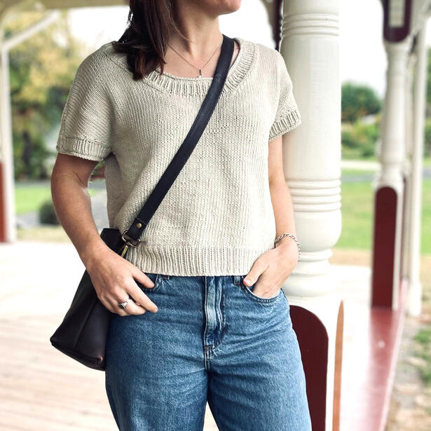 Women standing on verandah wearing jeans and knitted cotton tee